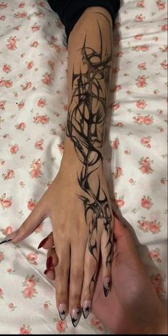 a woman's hand with tattoos on it