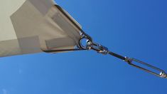 an open umbrella on a sunny day with blue sky in the background