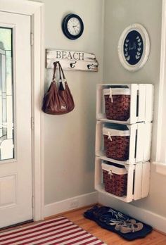 a white door with some baskets on it and a bag hanging from the wall next to it