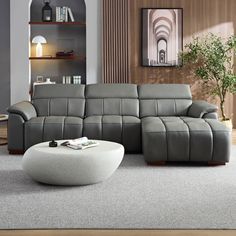 a modern living room with grey leather furniture