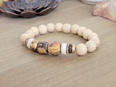 This Chunky Statement Wood and Bone Bead Bracelet features natural wood and clay beads with gold accents, creating a unique and vintage look. Perfect for boho layering, this bracelet adds a touch of style and personality to any outfit. Natural colored wooden beads Gold wood heishi colored beads Clay beads with gold accents Bone heishi beads Fits a wrist up to 6.5" Created in studio - Wilmington, NC **Last photo creates a layered look. You will get the one bracelet in description** Cheap Wooden Beaded Bracelets, Beads Clay, Boho Layering, Bone Beads, Wilmington Nc, Heishi Beads, Gold Wood, Layered Look, Clay Beads