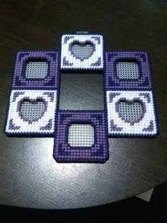 four purple and white coasters sitting on top of a table