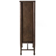 a tall wooden cabinet sitting on top of a white wall