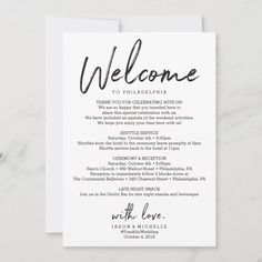 a welcome card with the words welcome written in black ink on white paper, sitting on a marble surface