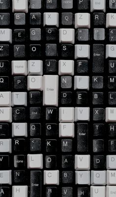 the keyboard is black and white with many different letters on it's keys,