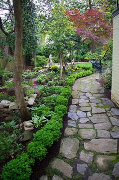 a stone path in the middle of a garden