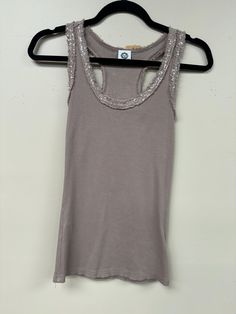 Indulge in the luxurious comfort and style of our Italian Sequence detail cotton tank top. With a racer or regular back, this essential piece is perfect for layering and adds a touch of elegance to any outfit. Available in basic colors, one size fits small to large. Adorned with sequence detailing on the neckline and sleeves, it's a necessary addition to your wardrobe. Luxury Fitted Classic Tank Top, Luxury Ribbed Women's Tank Top, Luxury Fitted Ribbed Tank Top, Luxury Elegant Sequined Tank Top, Beige Cotton Tank Top With Lace Trim, Black Racer, Winter Tops, Cotton Tank Top, Black Tank