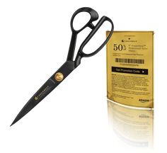 a pair of black scissors sitting on top of a yellow label next to it's packaging