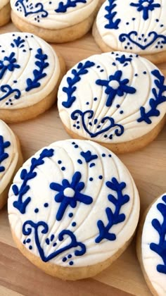 blue and white decorated cookies sitting on top of a wooden table