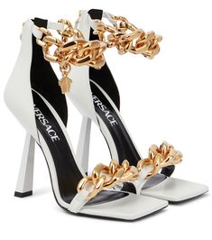 Stand head and shoulder above the rest with these white Medusa Chain sandals from Versace. Made from butter-soft lamb leather, they suspend eponymous pendants at the curb-chain ankle straps, and perch atop towering flared heels. | Versace Medusa Chain leather sandals Versace Heels, Versace Chain, Casual High Heels, Versace Shoes, Girly Shoes, Womens Shoes High Heels, Leather High Heels, Slipper Sandals, Carrie Bradshaw