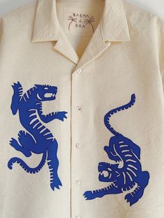 a white shirt with blue and black designs on it