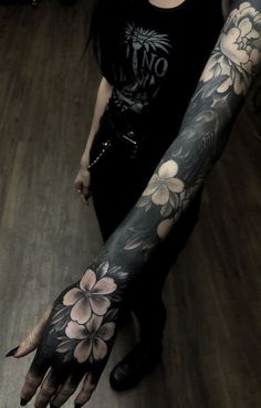 a woman with tattoos on her arm and hand