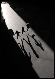 shadows cast on the floor as people walk by