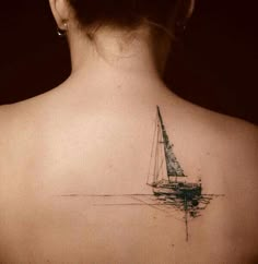 a woman with a sailboat tattoo on her back