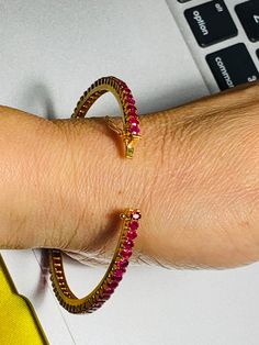 This bingle will elevate your whole outfit for any special occasions.  Natural Unheated Burmese Ruby Bangle in 18K Yellow Gold.  Weight of Ruby 35 pcs  5.2 ct Length and width of each Ruby  3.72x2.94 mm , 3.10x2.45 mm (Average) Length and Width of Bangle  Size 54.98 x54.27 mm Length and width of Ruby  63.71 mmx 3.90 mm Total weight of Bangle  11 gm Gemstone  -  Unheated Burmese Ruby Treatments - None Colour  -  Intense Red Transparency  -  Transparent / Highly Transparent Clarity -   VVS  14 pcs Diamond Bangle Bracelet With Gemstones, Gemstone Tennis Bracelet For Wedding, Wedding Bangle With Gemstone, Wedding Gemstone Tennis Bracelet, Formal Yellow Gold Ruby Bangle, Round Ruby Tennis Bracelet For Wedding, Wedding Tennis Bracelet With Round Ruby, Elegant Yellow Gold Ruby Bangle, Wedding Ruby Tennis Bracelet