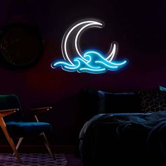 a room with a bed, chair and neon sign on the wall that says ocean waves