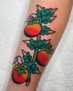 a tattoo design with tomatoes and leaves on the arm, done by an experienced artist