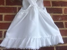 "We used this over a long sleeved red dress(not included).This is a beautiful white pinafore Swiss dot made in USA-in the 80s-no issues/smoke free environment-labeled sz 6- waist elasticized back 11\"-12\"/length (top to bottom) 21 1/2\"/petit lace trim on ruffle sleeve caps and bottom ruffle-no issues(37)" Fitted Lace Trim Dress For Picnic, White Lace Trim Dress For Picnic, Fitted Sleeveless Pinafore Dress With Ruffles, Cotton Lace Trim Dress For Picnic, Cute Fitted Broderie Anglaise Dress, Cute Fitted Dresses With Broderie Anglaise, White Sleeveless Cotton Pinafore Dress, Cute Cotton Swiss Dot Dresses, Cute Swiss Dot Cotton Dress