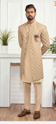 Elegant Beige Traditional Wear With Zari Work, Beige Raw Silk Sherwani With Dabka, Beige Sherwani With Resham Embroidery For Transitional Season, Beige Sherwani With Dupatta Traditional Drape, Beige Raw Silk Sets With Dabka Details, Beige Raw Silk Dabka Sets, Beige Sherwani With Resham Embroidery, Beige Dabka Raw Silk Set, Traditional Beige Raw Silk Sherwani