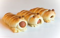 four pigs in a blanket shaped like hot dogs