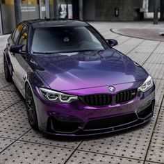 a purple car is parked on the street