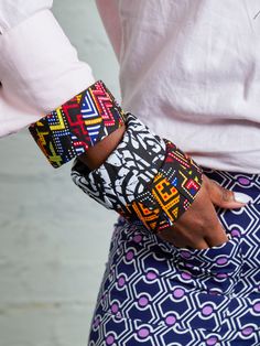 Compliment your look with these handmade African bangles. Crafted with light wood and cultural African wax prints. All pieces are carefully designed using traditional African fabrics, perfect for modern individuals seeking a unique touch. Perfect as a gift or to add to your bangle collection, these handmade pieces are sure to please. Please note that this item needs to be removed prior to showering, swimming or anything that could result in the fabric being damaged. Store in a dry place.Styling African Fabric Accessories, African Bangles, Bangle Collection, Fabric Bangles, African Accessories, African Fabrics