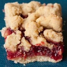 a piece of pie sitting on top of a blue cloth covered in crumbs