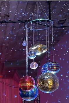 disco ball chandeliers hanging from the ceiling in a room with stars on the ceiling