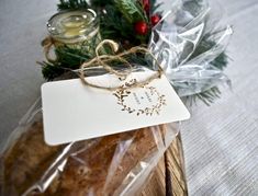 a package of cookies wrapped in cellophane and tied with twine on top of a wooden table