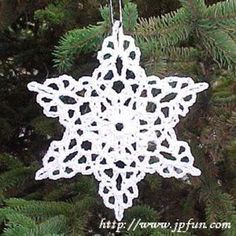 a crocheted snowflake ornament hanging from a tree