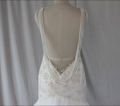 the back of a wedding dress with pearls on it