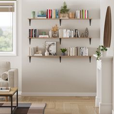 a living room filled with furniture and bookshelves next to a window in front of a white wall