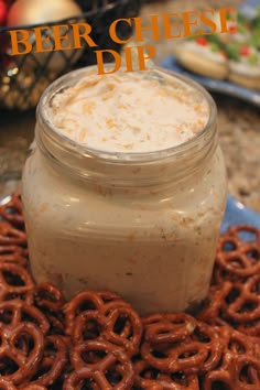 a plate topped with pretzels and a jar of beer cheese dip next to it