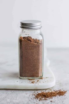 a glass jar filled with brown powder on top of a white counter