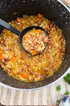 a pot filled with beans and rice on top of a table