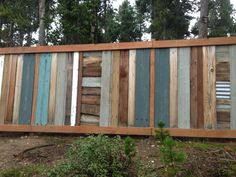 a fence made out of wooden boards in the woods