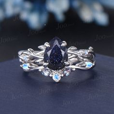 a fancy ring with a pear shaped blue diamond