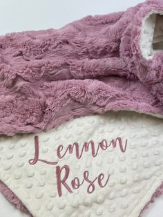 a pink and white blanket with the name lemon rose written on it in cursive writing