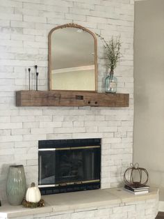 a white brick fireplace with a mirror above it