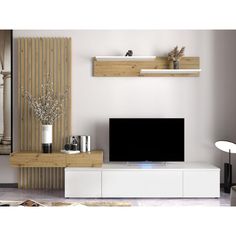 a living room with white furniture and a flat screen tv mounted on a wooden wall