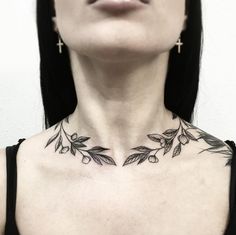 a woman's chest with tattoos on it