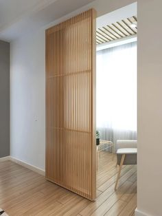 an empty room with wooden slats on the wall and wood flooring in it