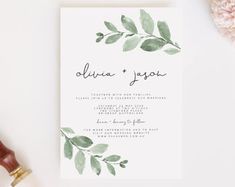 a wedding card with greenery on it