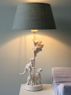 a lamp that is sitting on top of a table next to a stuffed animal toy