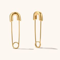 The unique design features a sleek and simple pin, creating a look that is both modern and sophisticated.These earrings are durable and long-lasting, ensuring that they will be a cherished addition to your jewelry collection for years to come. Perfect for dressing up any outfit, these earrings are a must-have for any fashion-conscious individual. Trendy Safety Pin Single Earring, Trendy Safety Pin Earrings For Pierced Ears, Trendy Single Safety Pin Earring, Minimalist Safety Pin Jewelry For Pierced Ears, Minimalist Safety Pin Earrings, Safety Pin Earrings As Gift, Minimalist Gold Safety Pin Earrings, Trendy Paperclip-shaped Earrings As Gift, Trendy Paperclip Earrings As Gift