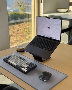 an open laptop computer sitting on top of a desk next to a mouse and keyboard