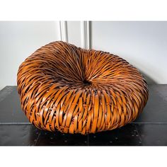 a round chair made out of wicker sitting on top of a tile floor