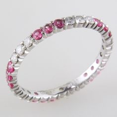 a white gold ring with pink and white stones