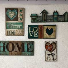 the wall is decorated with many different types of home signs and magnets on it