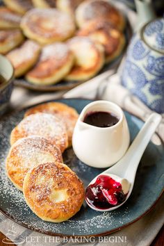 ricotta pancakes on a plate with jam and powdered sugar